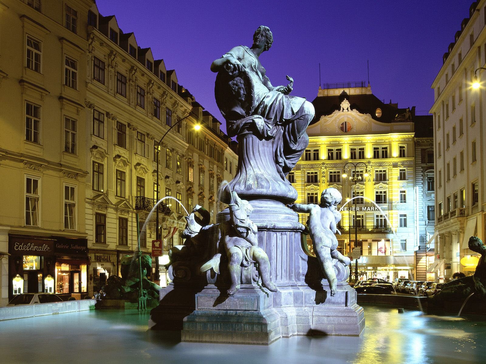 fontanna w centrum miasta urocza rzeźba oświetlenie miasta noc posągi światła miast