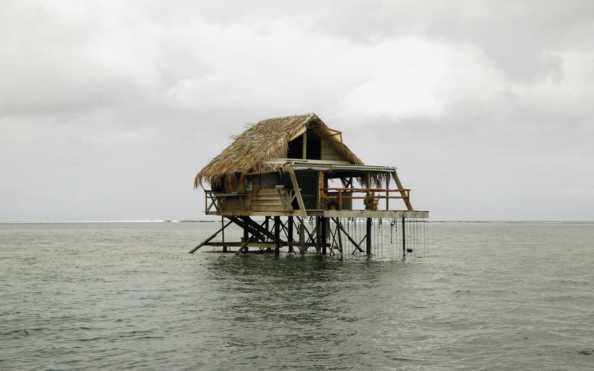 casa de agua techo de paja cabaña edificios agua islas superficie naturaleza paisaje casa horizonte mal tiempo cielo gris nublado