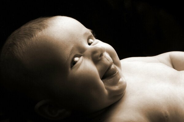 A small child shows his tongue