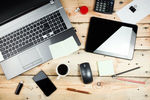 Laptop, tablet, phone, lighter and a cup of coffee
