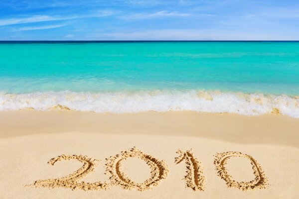 Inscription on the sand by the blue sea 2010