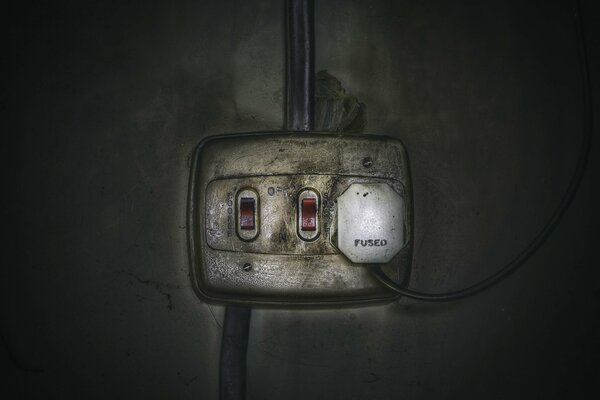 Switch with red buttons on the old wall