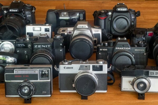 Macro photos of vintage photo cameras on a wooden background