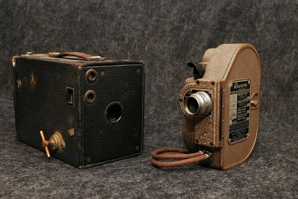Old two cameras on a gray background