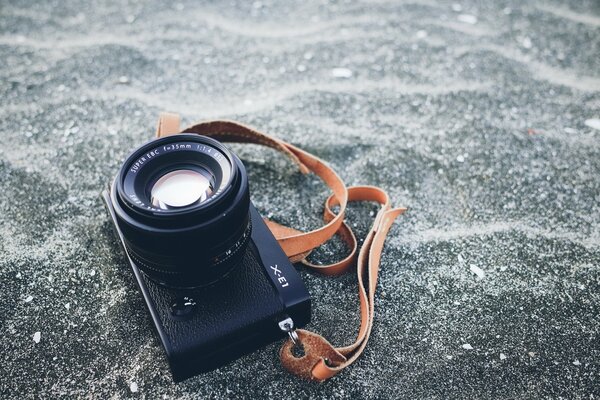 A beautiful camera is lying on the sand