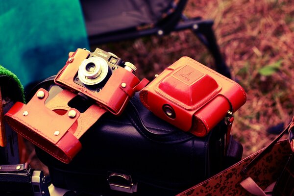 Three red cameras are on the bag