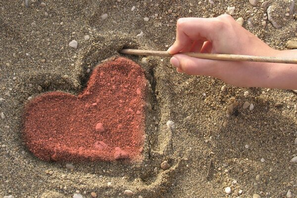Muster auf Sand in Form eines Herzens