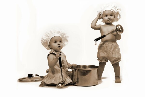 Little cooks with a saucepan and ladles