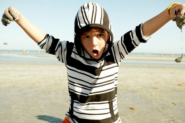 Boy child playing with sand nature