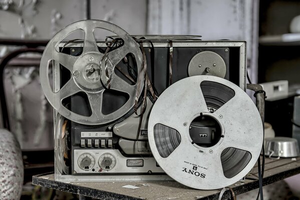 An old tape recorder with torn tape cassettes