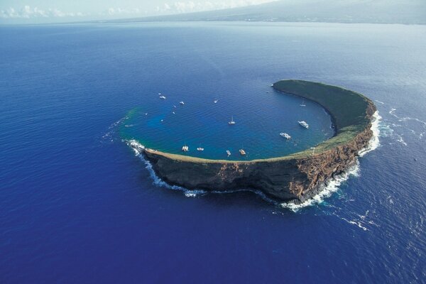 A mountain range in the shape of a thin moon in the ocean