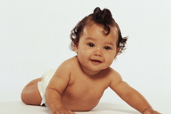 Portrait of a curly-haired baby with black eyes