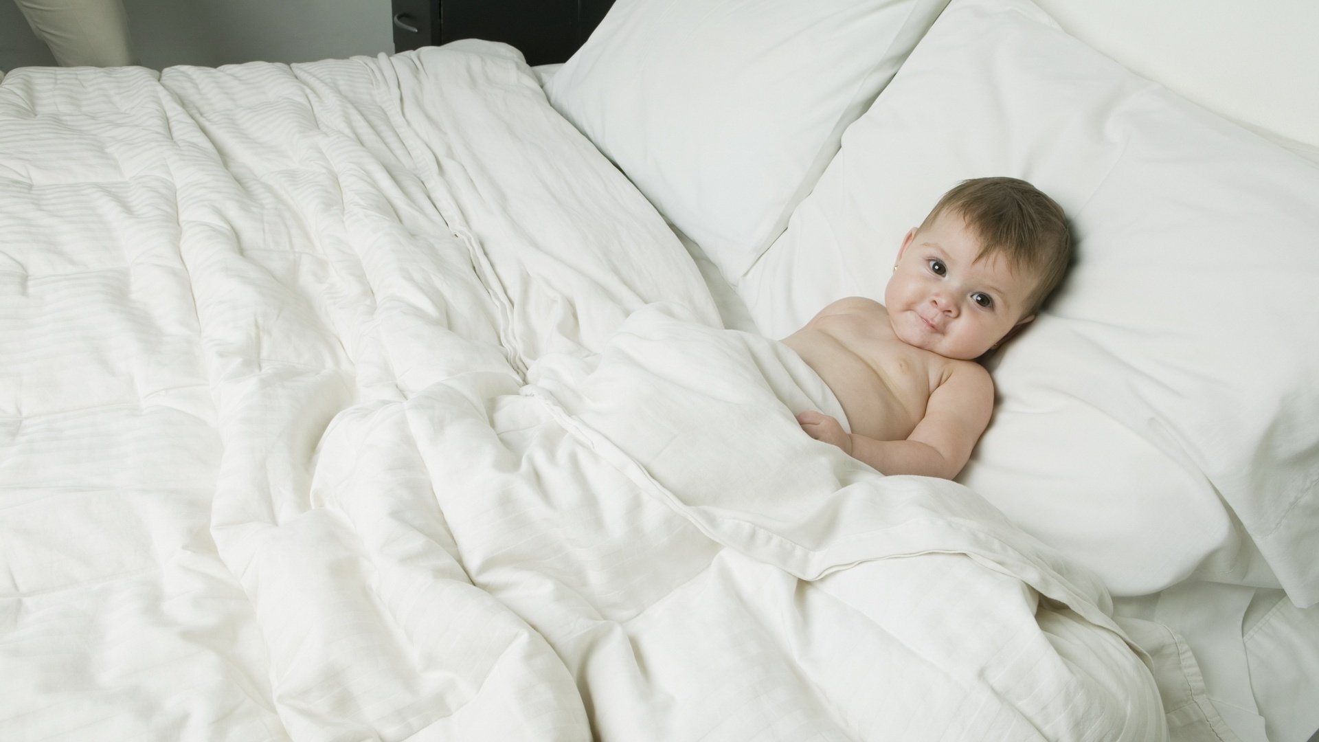 im bett der eltern schlafenszeit vorbereiten zufriedenes gesicht weiße farbe blick gesicht augen baby baby krümel zappeln egoza bett weiße laken bett augen