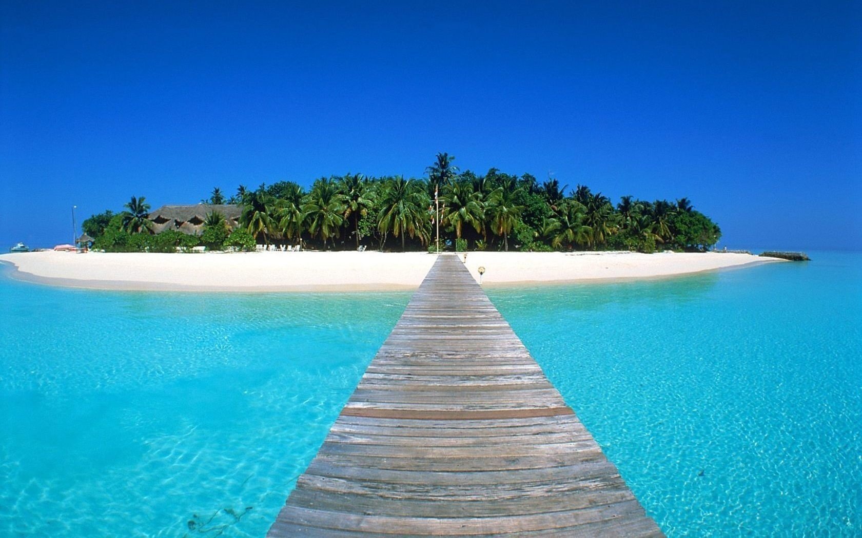 ponte di legno spiaggia case acqua cielo isole riva paradiso azzurro turchese oceano tropici