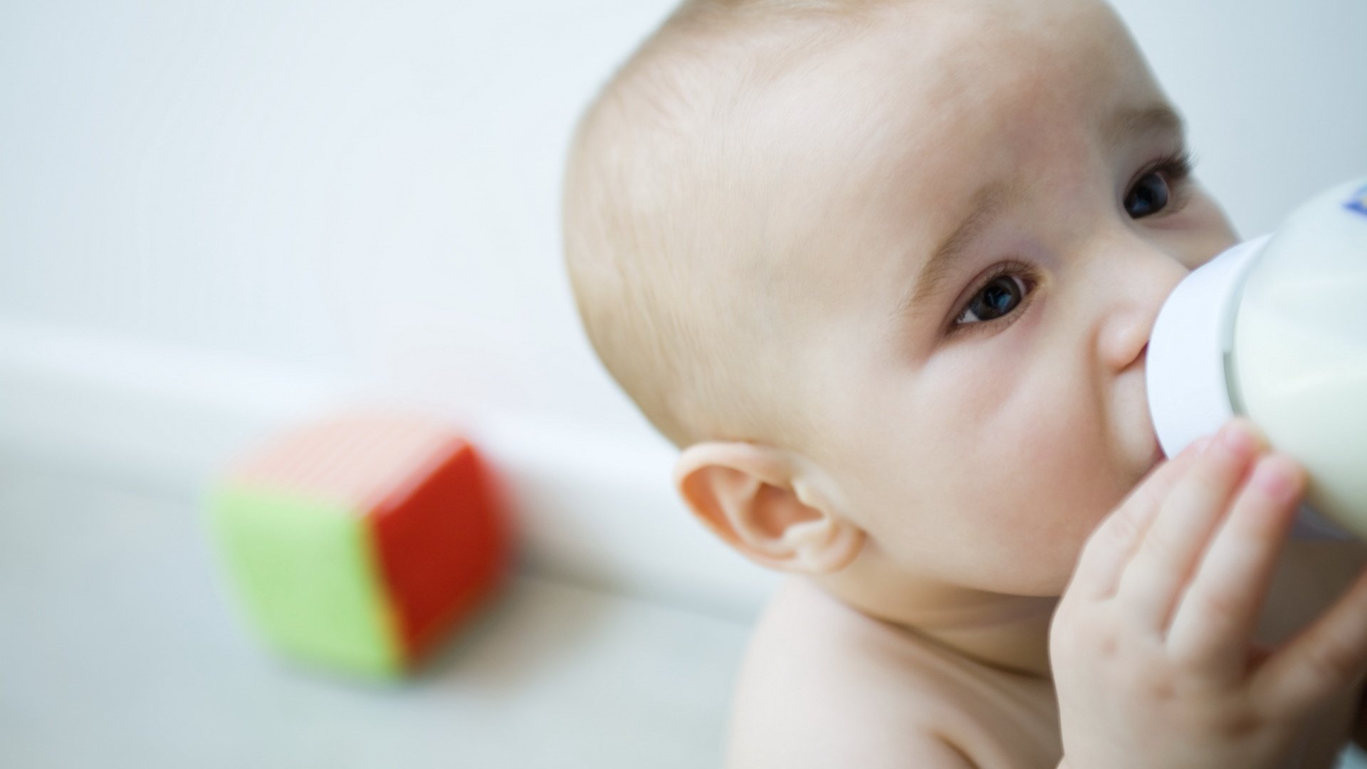 begging eyes drinking milk baby portrait look eyes face cube toys feeding milk bottle baby baby eye