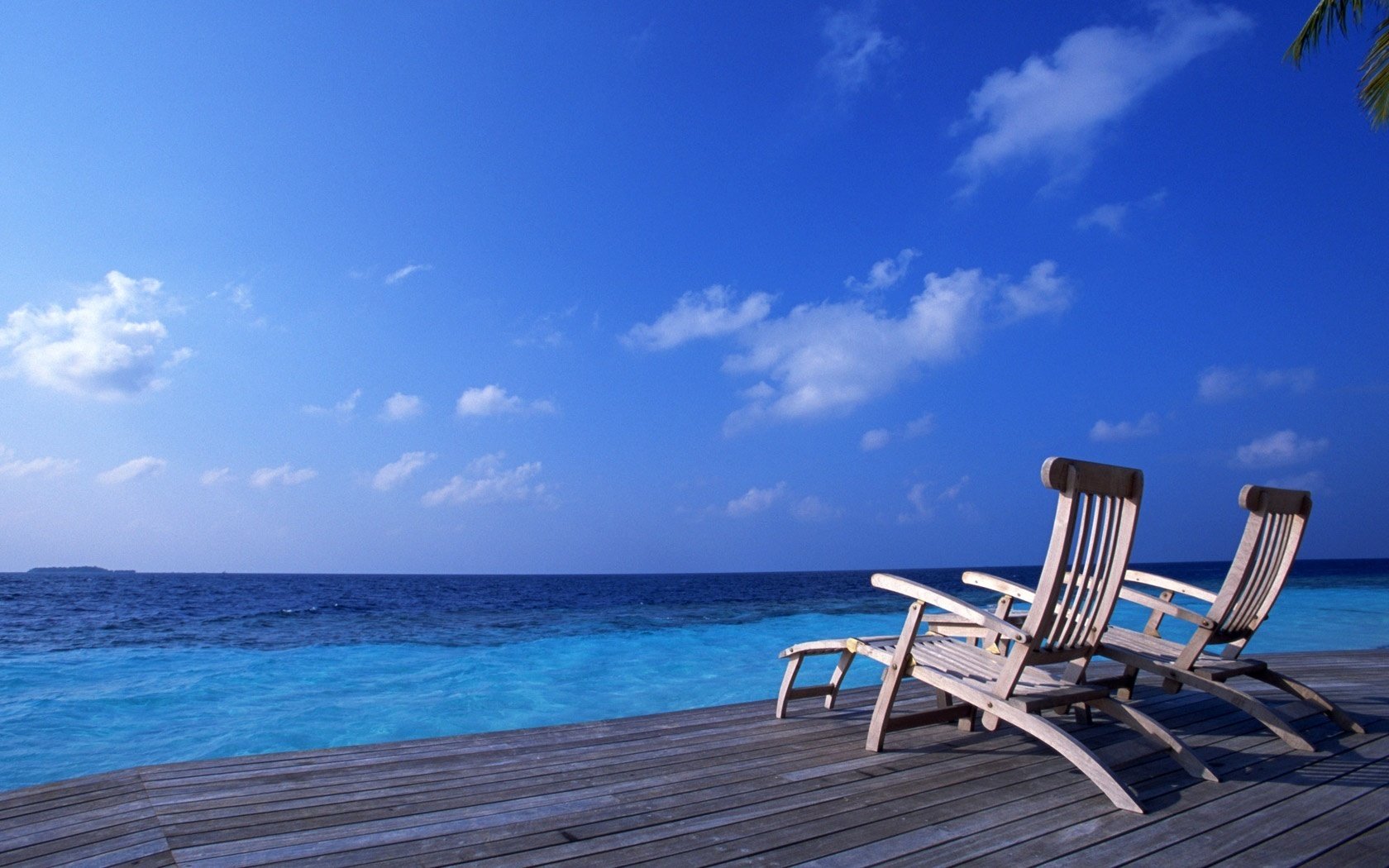 the overflow of water marina a couple of sun loungers beach water the sky sun loungers stay vacation resort clouds sea pierce pier blue surface