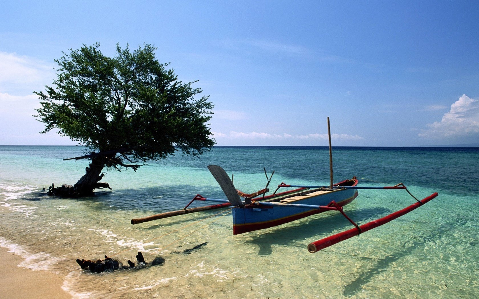 a fishing boat shallow water wave water the sky sea horizon nature landscape tree surf clouds summer heat