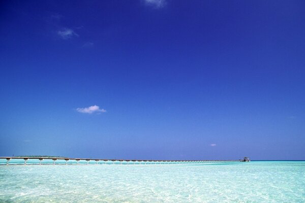 A long wooden path through the paradise of the blue ocean