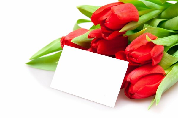 Bouquet of tulips with a note on the table