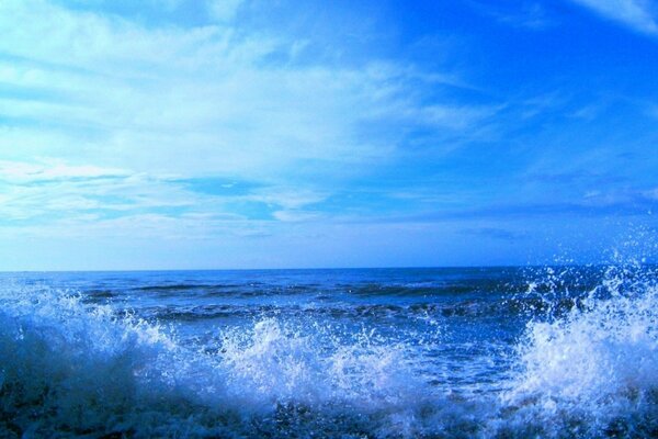 Splashes of water during the surf against the blue sky