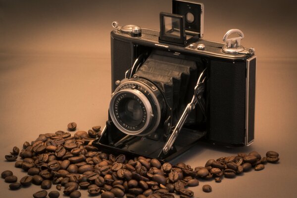 The camera is on the table with coffee beans