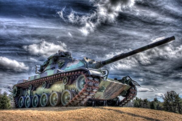 Multicolored iridescent tank on a background of gray clouds