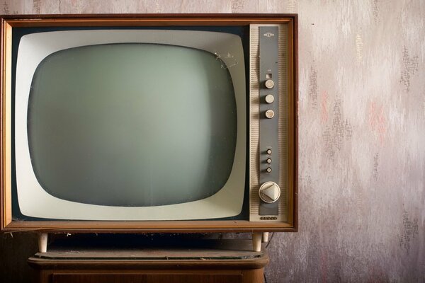 Vintage TV on a pink wall background