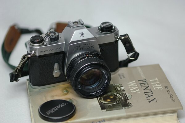 A camera on a book with a shutter cover