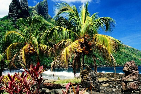 Stone statues under palm branches