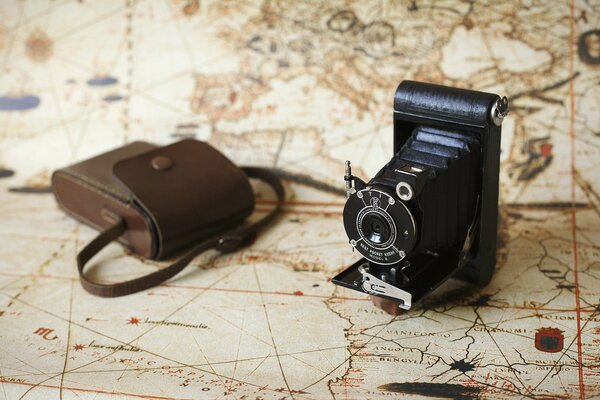 Vintage camera and cartographic background