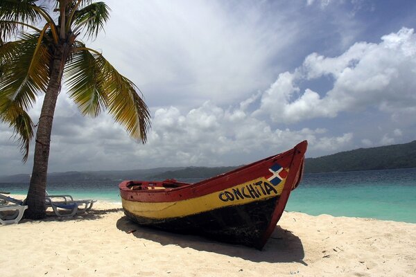 A boat on the shore against the background of thunderclouds