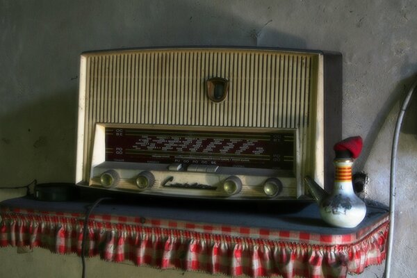 An old radio receiver on the tablecloth