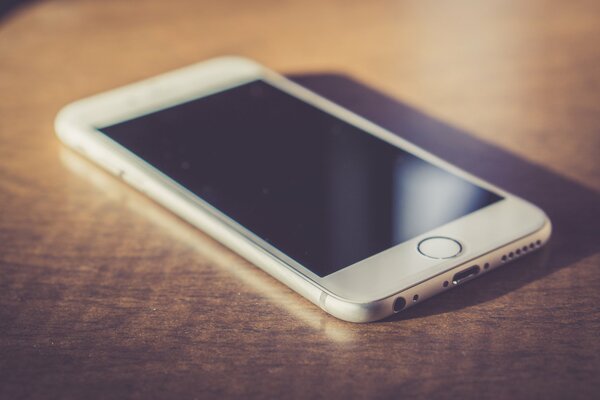 White iPhone located on the table