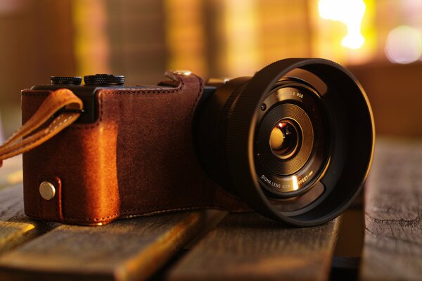 Professional camera on a wooden bench