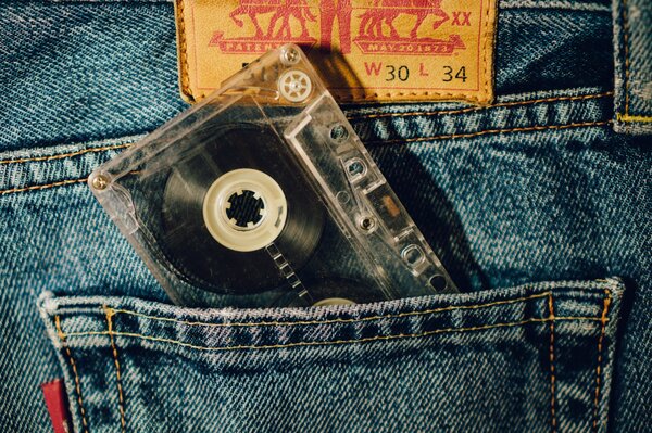 A cassette sticking out of the back pocket of jeans