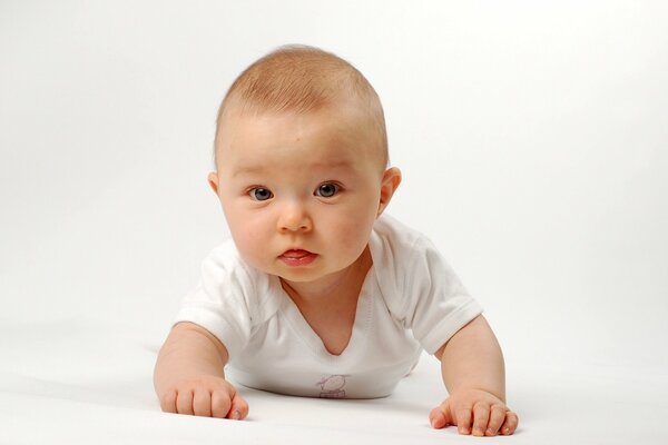 Cheerful little boy in a white blouse