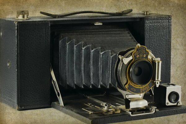 An old camera on a beige background