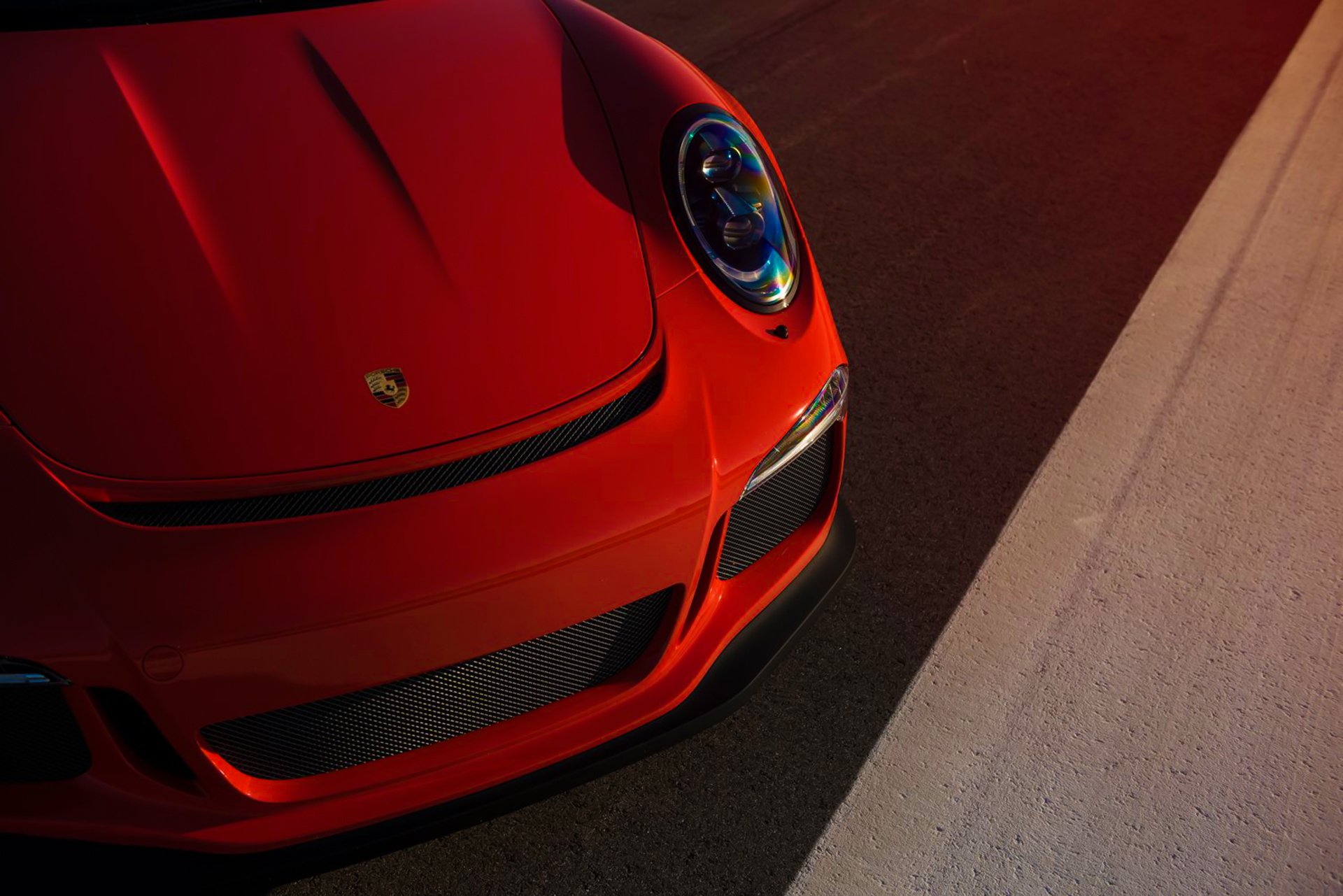 porsche 911 gt3rs orange farbe supersportwagen vorne licht sonne