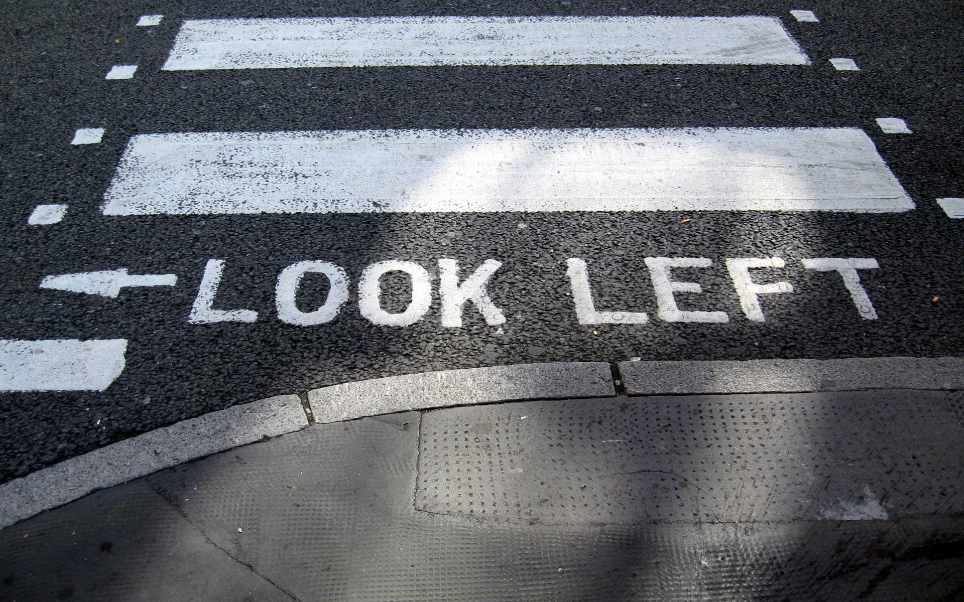 transition look left look left sidewalk road paint stripes words word pointer inscription arrow