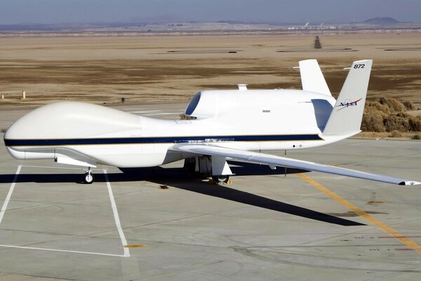 A white plane on the runway