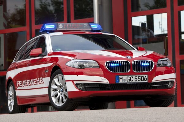 Red BMW car with flashing lights