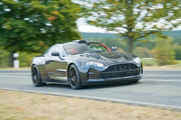Aston Martin supercar at speed on the road