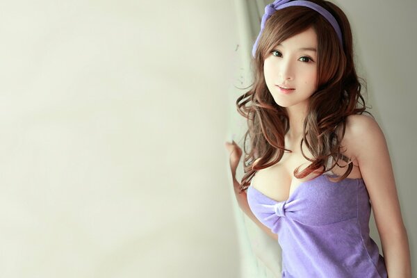 Asian woman with a big bust in a lilac sundress