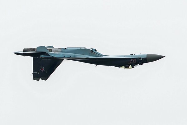 The Su-35 plane does aerial stunts at an air show