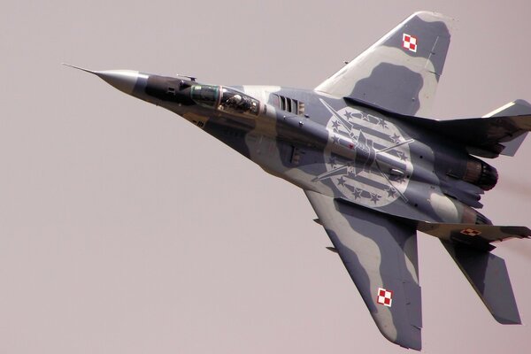 The mig 29 plane is flying in the sky