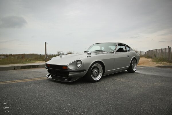 Gray nissan datsun on the highway