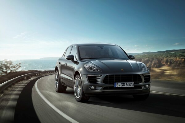 Dark-colored SUV on the background of the sea