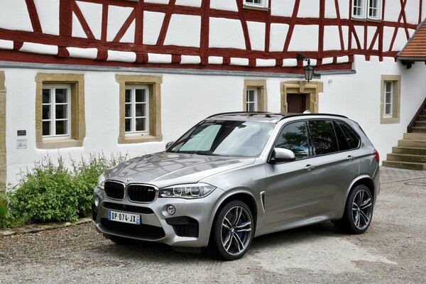 BMW X5 , 2015 on the background of the metallic house