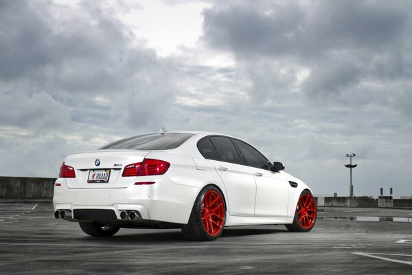 White BMW against a stormy sky