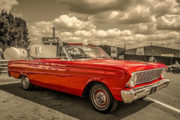 Red retro car on a solid brown background